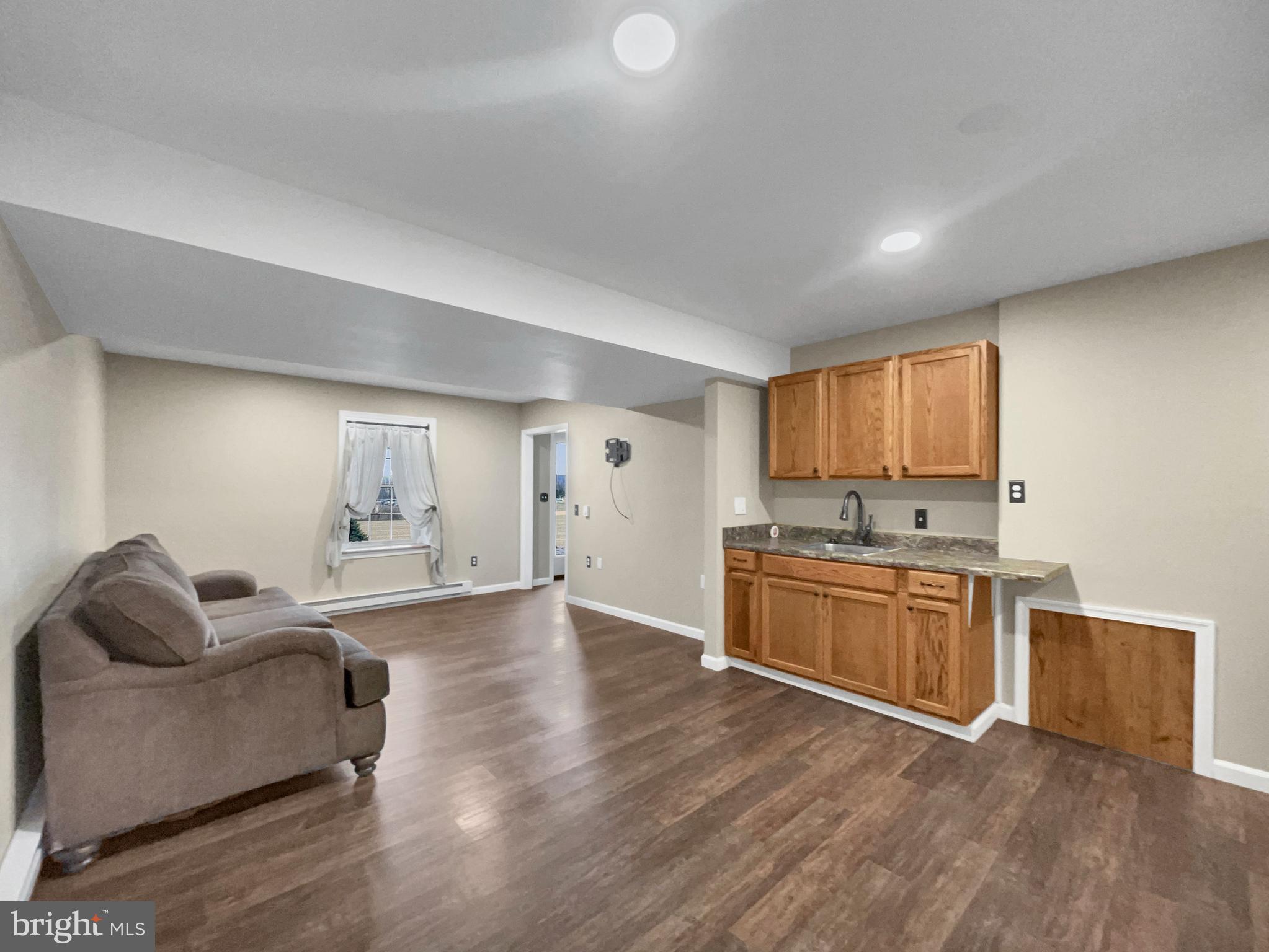 65 South Reamstown Road Stevens, PA 17578 - Photo 24 of 32 a living room with stainless steel appliances granite countertop furniture and a wooden floor