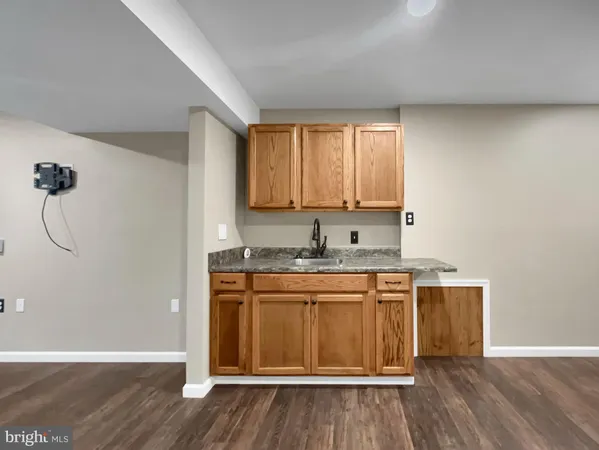 a living room with a couch and a wooden floor