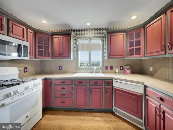 a kitchen with a sink stove and cabinets