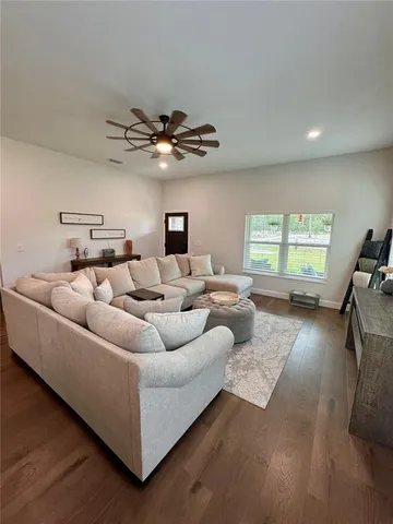 a kitchen with kitchen island a refrigerator a stove a sink and a chairs