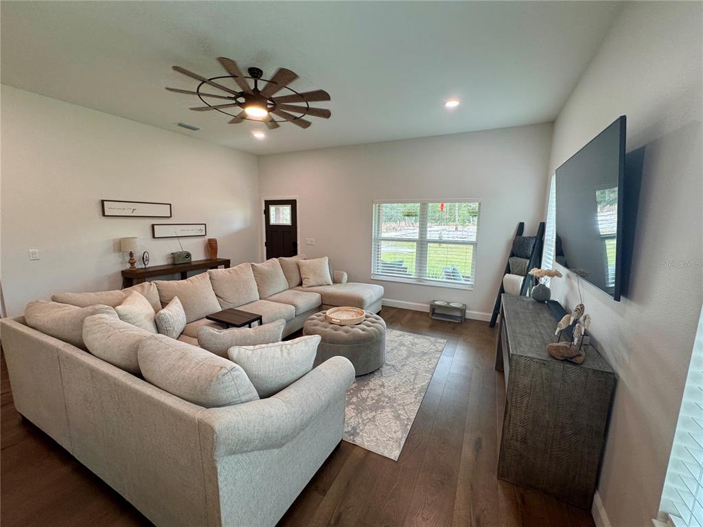 4275 Beacon Light Road Edgewater, FL 32141 - Photo 13 of 48 a living room with furniture and a flat screen tv