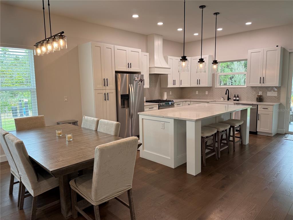 4275 Beacon Light Road Edgewater, FL 32141 - Photo 16 of 48 a large kitchen with a table and chairs