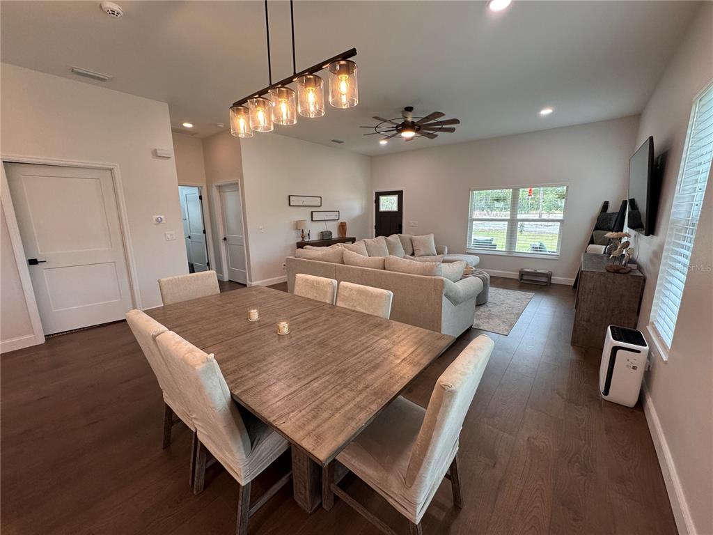 4275 Beacon Light Road Edgewater, FL 32141 - Photo 17 of 48 a view of a dining room with furniture and a chandelier