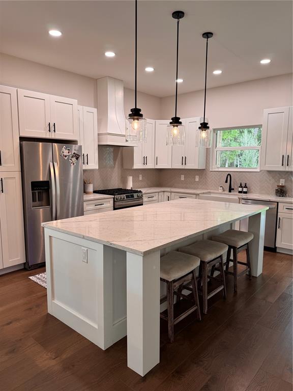 4275 Beacon Light Road Edgewater, FL 32141 - Photo 19 of 48 a kitchen with kitchen island a refrigerator a stove a sink and a chairs