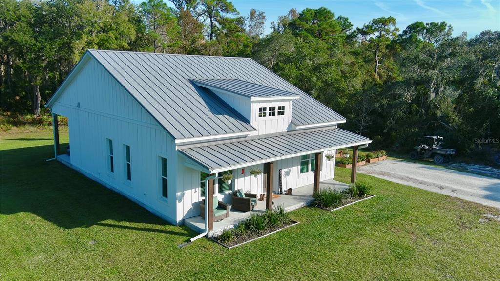 4275 Beacon Light Road Edgewater, FL 32141 - Photo 2 of 48 a aerial view of a house next to a big yard and large trees