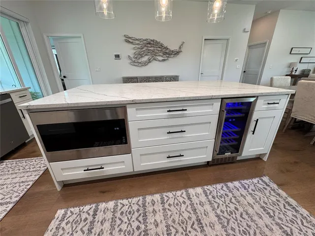 a bathroom with a sink a toilet a mirror and shower