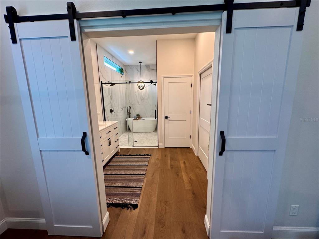 4275 Beacon Light Road Edgewater, FL 32141 - Photo 38 of 48 a view of a hallway with wooden floor and staircase