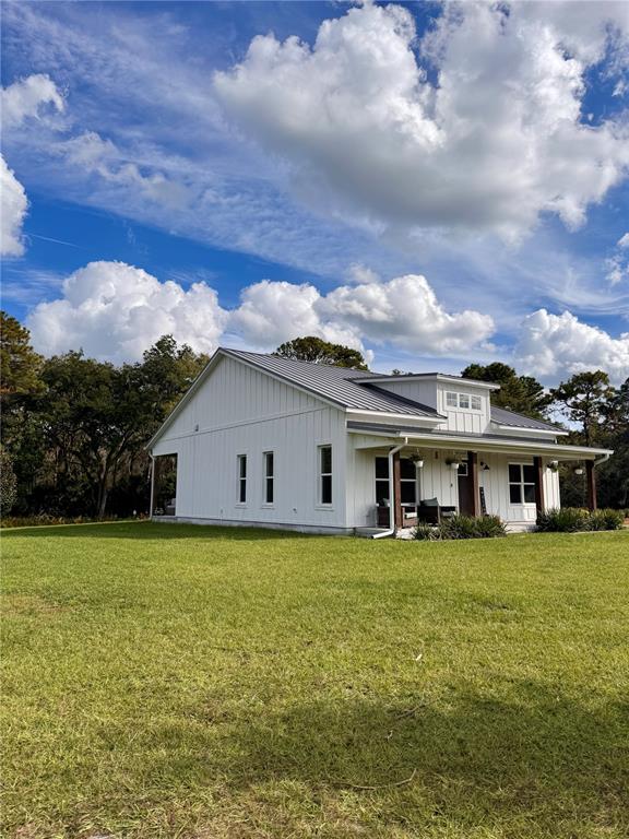 4275 Beacon Light Road Edgewater, FL 32141 - Photo 7 of 48 a view of a house with a big yard and potted plants