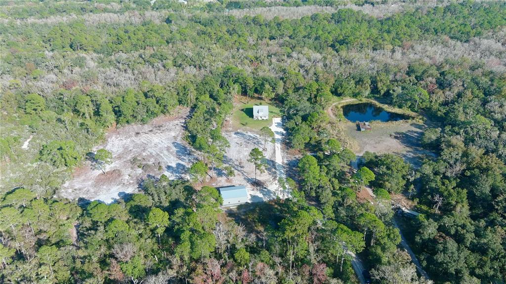 4275 Beacon Light Road Edgewater, FL 32141 - Photo 8 of 48 an aerial view of residential house with outdoor space and trees all around