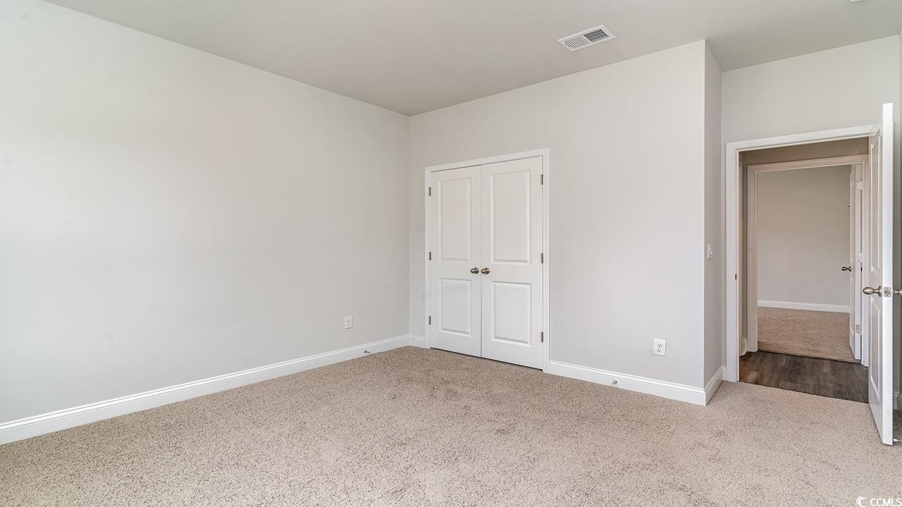 115 Rnch Hvn Drive Murrells Inlet, SC 29576 - Photo 9 of 25 Unfurnished bedroom with light carpet and a closet