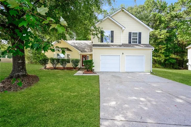 a front view of a house with garden