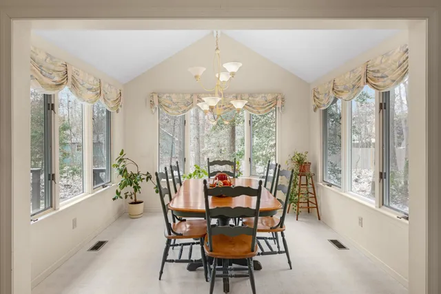 a view of a dining room with furniture large windows and wooden floor