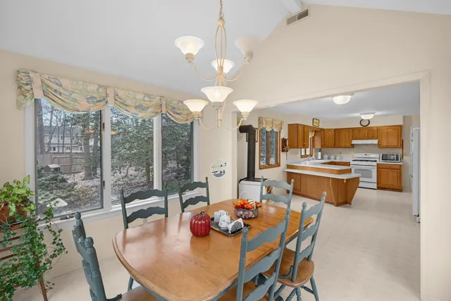 a dining room with a table or chairs and a dining table with garden view