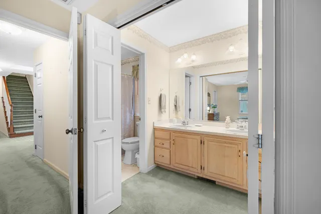 a bathroom with a double vanity sink and mirror