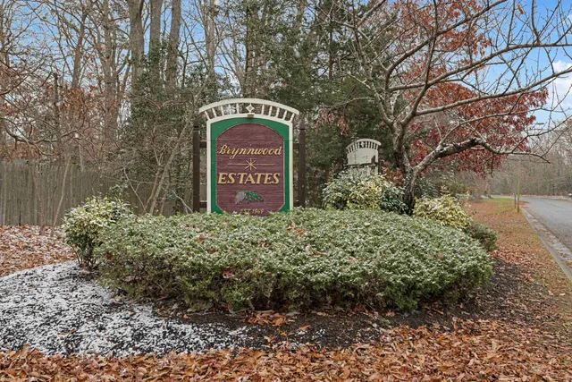 a sign that is sitting in front of flowers