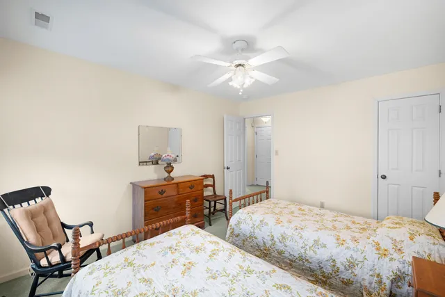 a view of a room with chairs and wooden floor