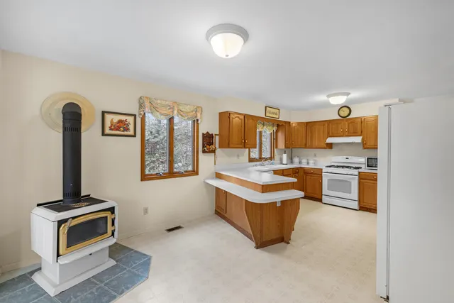 a kitchen with stainless steel appliances granite countertop a stove and a sink
