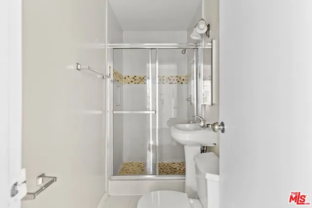 a bathroom with a shower and a sink