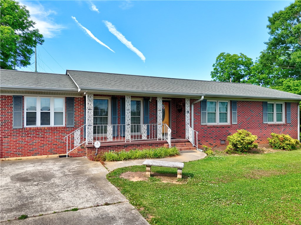 A well-maintained brick facade and inviting porch create classic curb appeal.