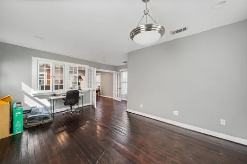 a view of a livingroom with furniture hardwood floor and a window