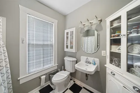 a bathroom with a toilet sink and mirror