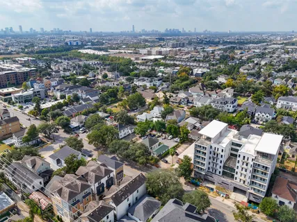an aerial view of residential houses with city view