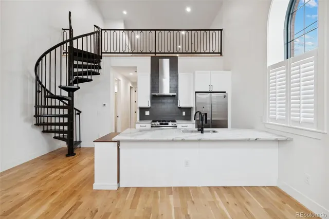 a view of living room with wooden floor and staircase