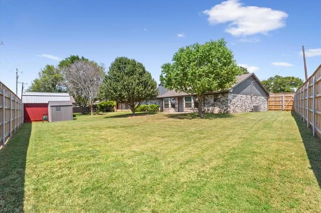 a house view with swimming pool and trees in the background