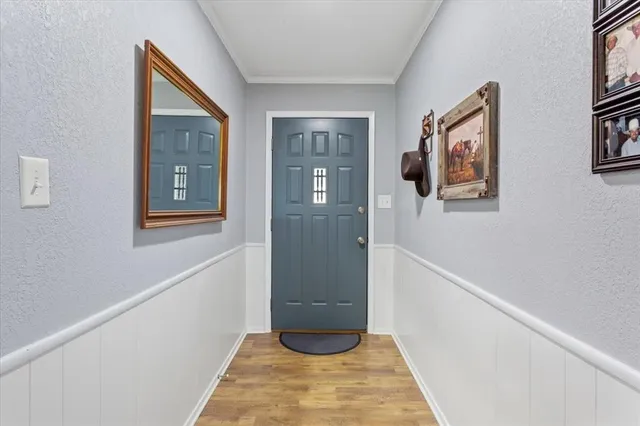 a view of an entryway with wooden floor