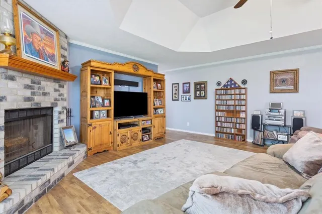 a living room with furniture a flat screen tv and a fireplace