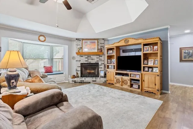 a living room with furniture a flat screen tv and a fireplace