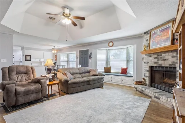 a living room with furniture a window and a fireplace