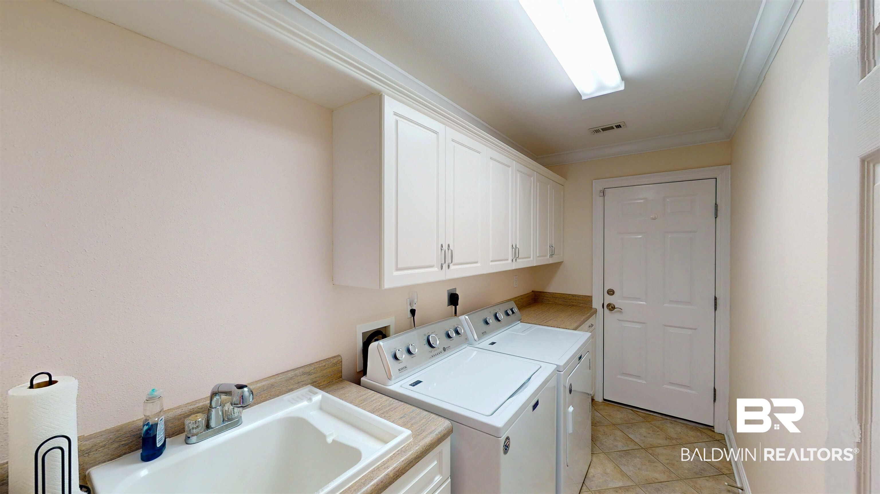 214 Hemingway Loop Foley, AL 36535 - Photo 17 of 67 Laundry room with crown molding, separate washer and dryer, cabinet space, and light tile patterned floors