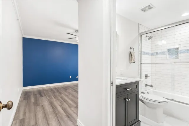 a bathroom with a granite countertop sink toilet a mirror and shower