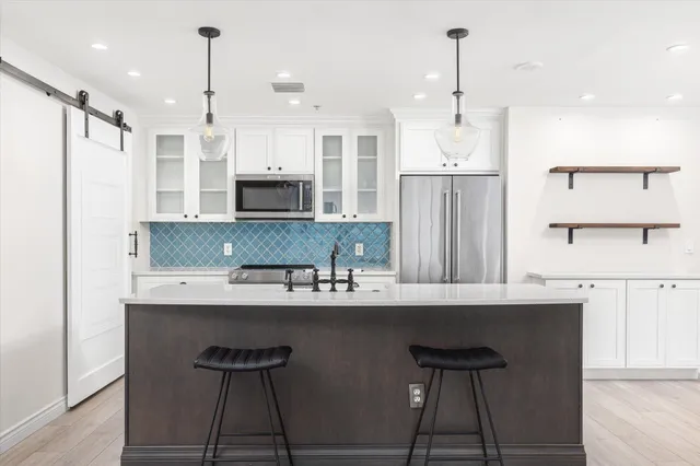 a kitchen with stainless steel appliances a sink stove and refrigerator