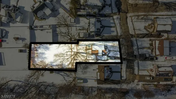a front view of a house with a yard covered in snow
