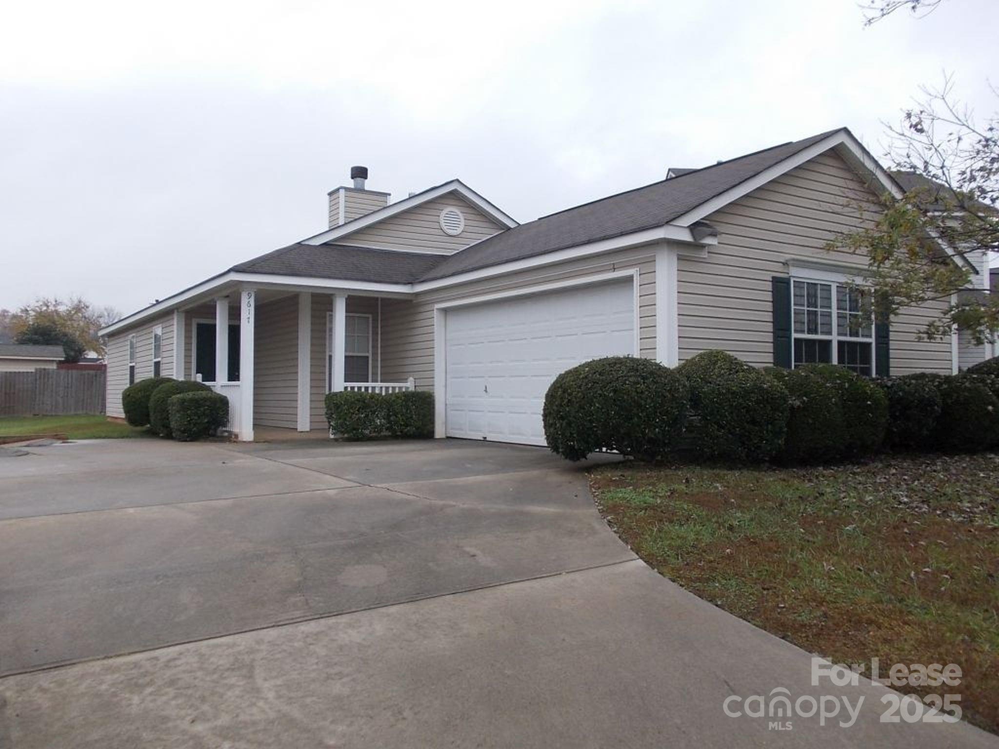 a front view of a house with a yard and a garage