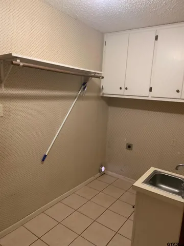 a view of storage and utility room with closet