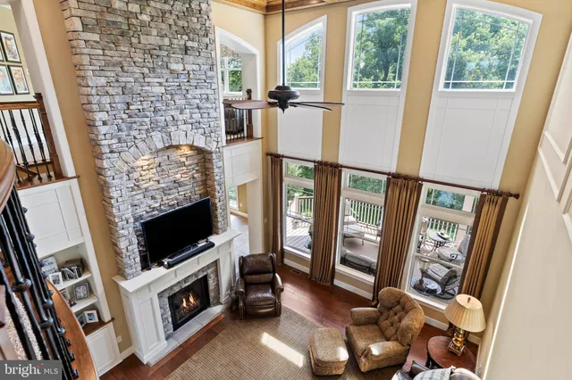 a kitchen with stainless steel appliances granite countertop a sink a stove and a wooden floors