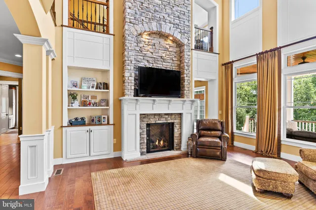 a dining room with furniture a chandelier and glass door