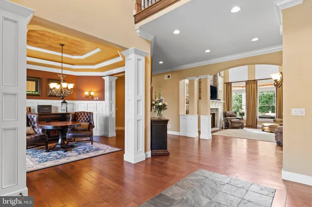 a living room with furniture large windows and a fireplace
