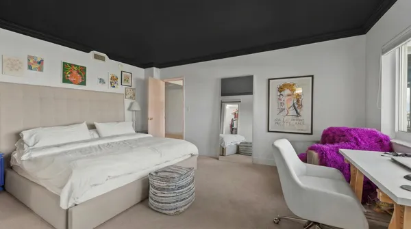 a bedroom with a bed and a couch