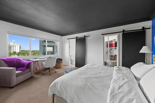 a bedroom with a bed and a couch