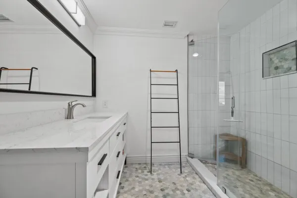 a bathroom with a granite countertop sink a toilet and shower