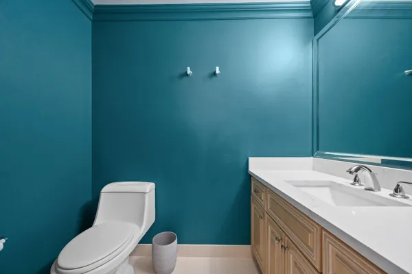 a bathroom with a toilet a sink and mirror