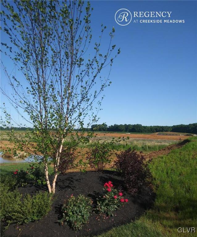 6916 Cedar Drive Bath, PA 18014 - Photo 9 of 19 a view of a lake with a garden