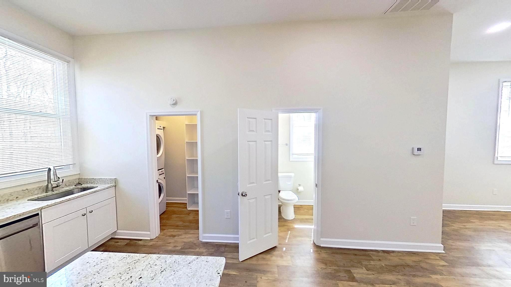 3842 Stoneybrook Road, Unit B White Plains, MD 20695 - Photo 12 of 23 a spacious bathroom with a granite countertop sink a mirror and a shower