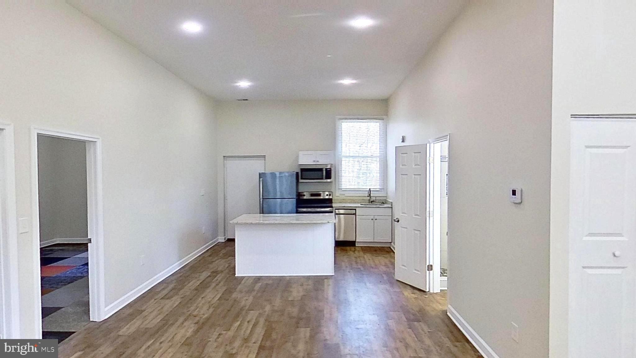3842 Stoneybrook Road, Unit B White Plains, MD 20695 - Photo 16 of 23 a view of kitchen with stainless steel appliances kitchen island wooden floor and window