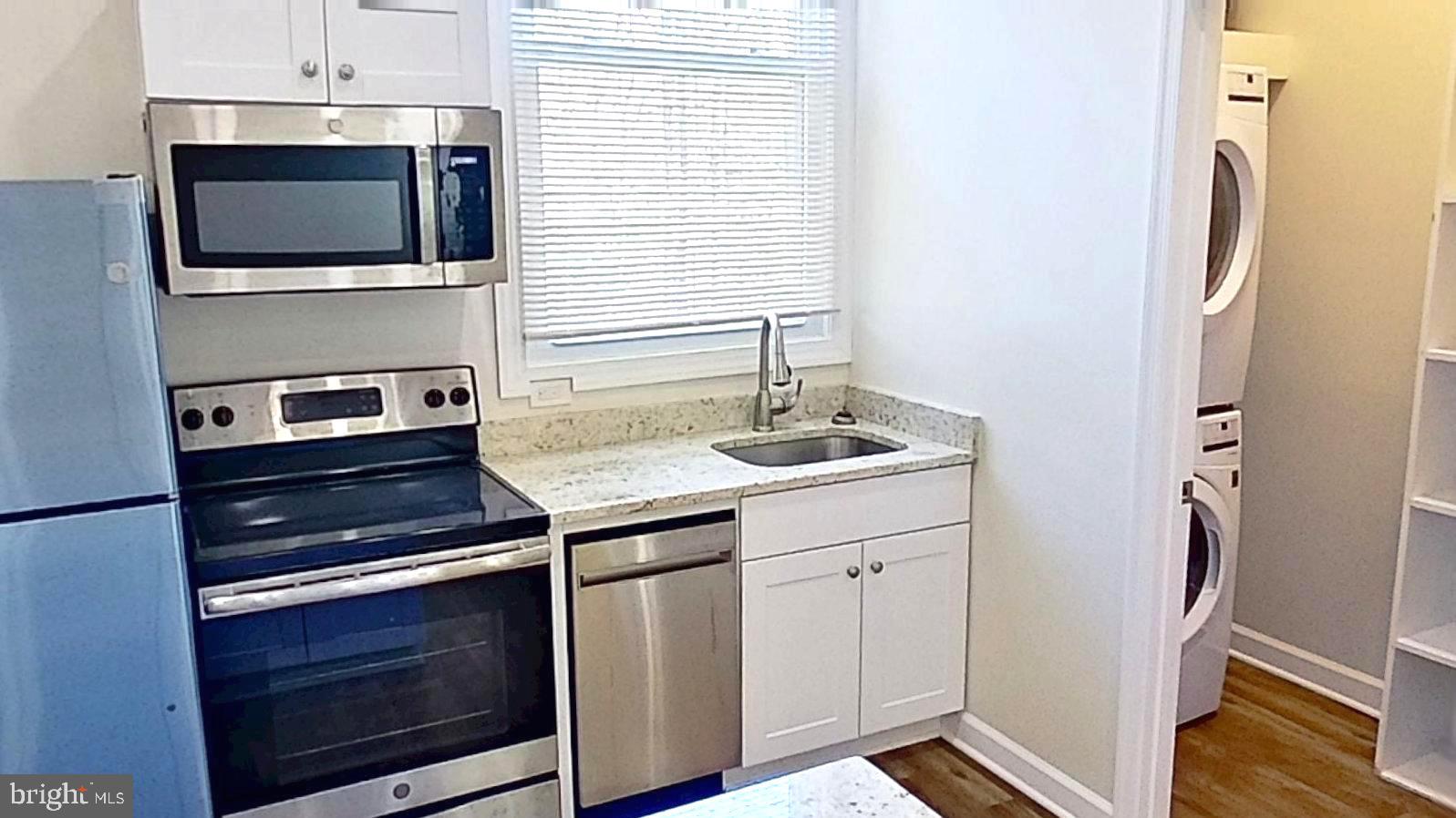 3842 Stoneybrook Road, Unit B White Plains, MD 20695 - Photo 17 of 23 a kitchen with a stove and a microwave