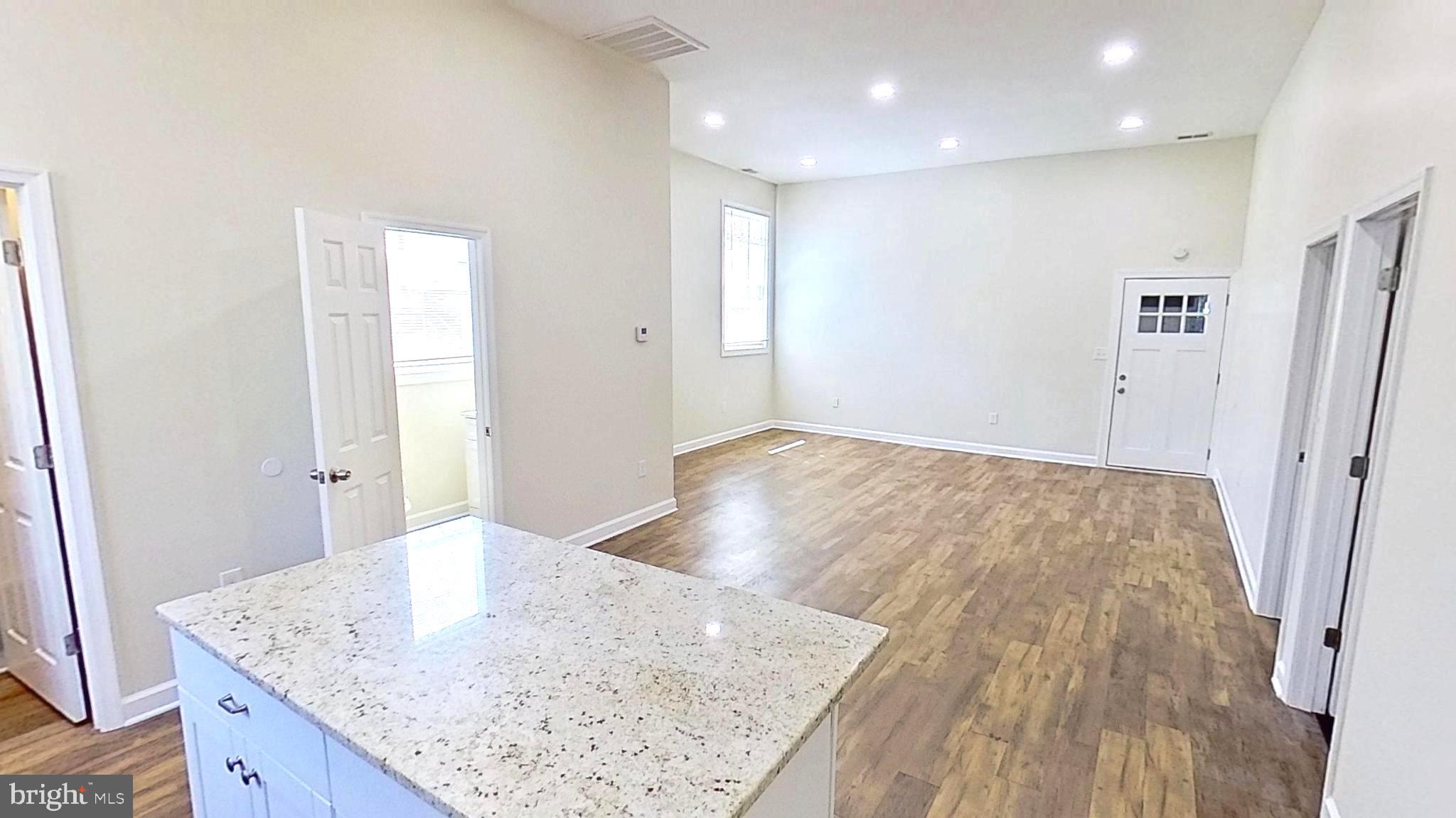 3842 Stoneybrook Road, Unit B White Plains, MD 20695 - Photo 19 of 23 a view of kitchen island wooden floor